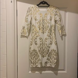 White dress with gold sequins.